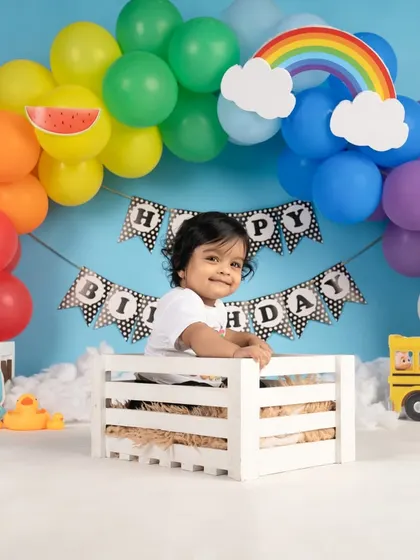 Peeking out of a white crate, this little one is having so much fun exploring the colorful Cocomelon set.