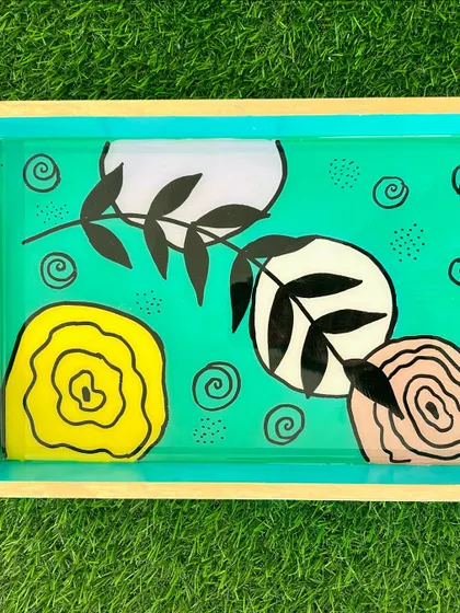 A beautifully crafted resin-painted tray with a modern, abstract design. A great way to add a pop of color to your home decor.