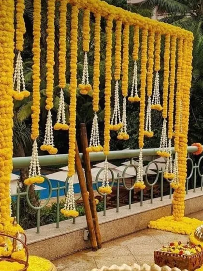 A simple and traditional Haldi backdrop made entirely of marigold strings. This setup is perfect for outdoor events and has a classic, timeless appeal.
