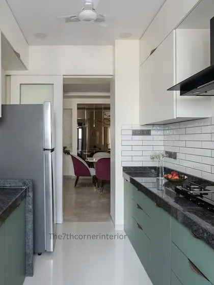 A full view of the kitchen, showing the parallel layout and the sliding door that separates it from the living space. This design offers both privacy and the flexibility of an open-concept feel.