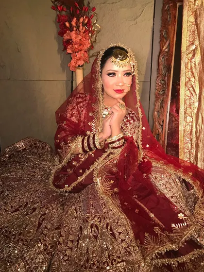 A moment of prayer and gratitude. The makeup is kept classic and elegant to match the solemnity and joy of the occasion.