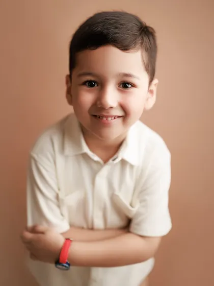 It's not just about babies. I love capturing the bright, shiny-eyed joy of older kids too. This studio portrait shows the pure, happy personality of a young boy, a memory his family will treasure as he grows.