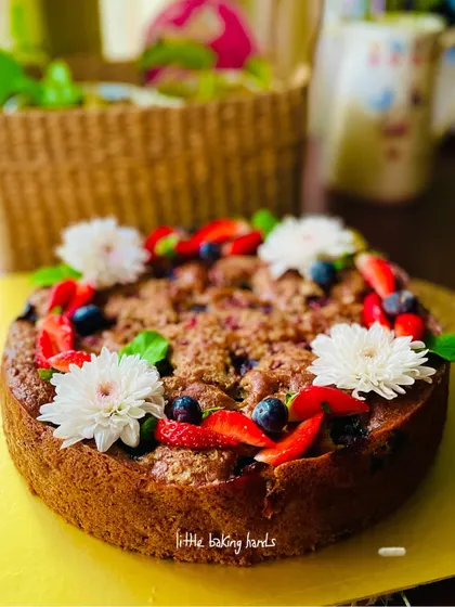 A beautiful example of my berry cakes. This one is a vanilla strawberry lime cake with a crumble topping, decorated with fresh berries and flowers.