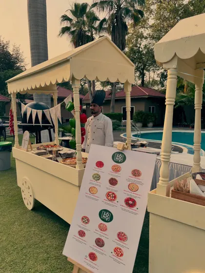 My catering carts are perfect for any outdoor event, like this poolside kids' party. The setup includes a clear menu board so everyone can see the delicious Neapolitan pizza options available.