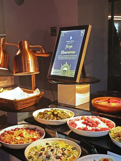 A lavish buffet spread at a 40th birthday party, featuring a wide array of salads and cold dishes. The "Soya Shawarma" station sign indicates one of the many live-action elements available.
