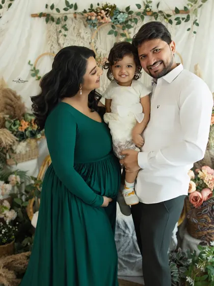 A happy family portrait with their first child. This shot beautifully captures the love and excitement of a growing family during their maternity session.