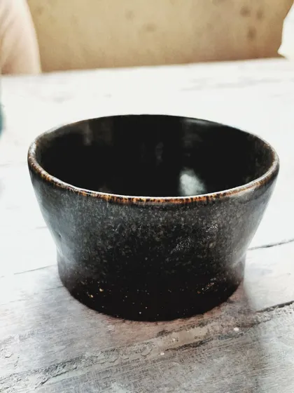 After her beginner's course, this student rejoined for the advanced level. She created beautiful wheel-thrown mugs and bowls, and also explored sculptural hand-building, creating this unique candlestick holder.