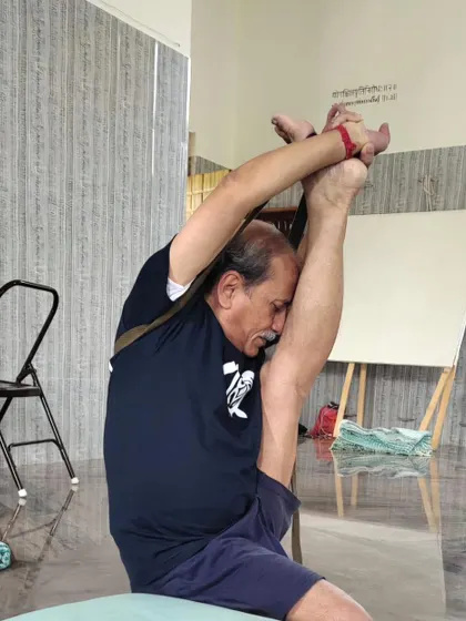 An advanced standing balance pose requiring extreme flexibility and control.
