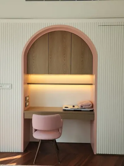 A sneak peek of a tranquil study nook we're creating at our Indiabulls Blu project. The soft pink arch and fluted wall panels create a calm and focused workspace with a touch of elegance.