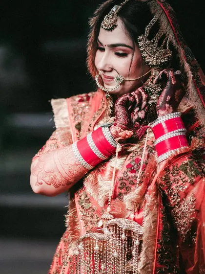 A close-up of the Sikh bride, focusing on her traditional jewelry and 'chooda'.