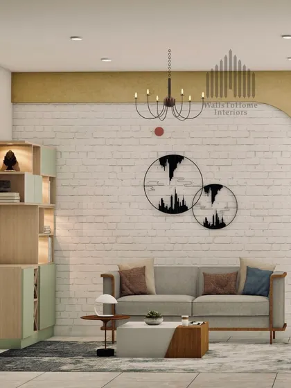 A cozy living room arrangement with a stylish grey sofa, unique wall art, and a functional cabinet. The curved accent wall adds a soft, architectural element to the space.