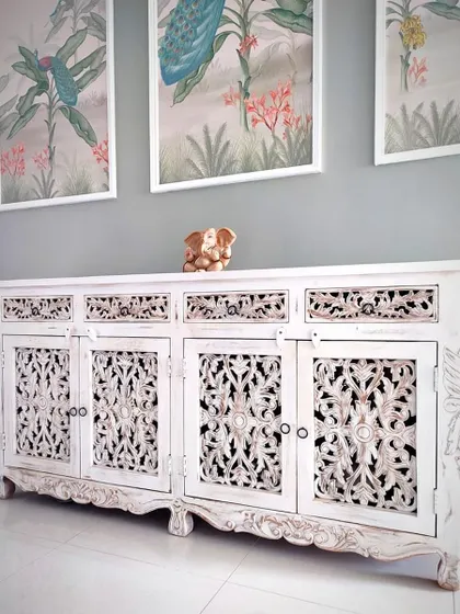 Carving out some serious style because basic furniture is so last season! An intricately carved white console table that adds a touch of traditional art.