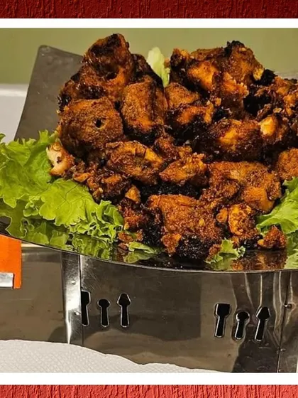 A close-up of our delicious chicken starter, served in a stylish metal container to keep it warm.