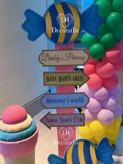 A fun and personalized directional signpost guides guests through the sweet different aspects of the Candyland party.