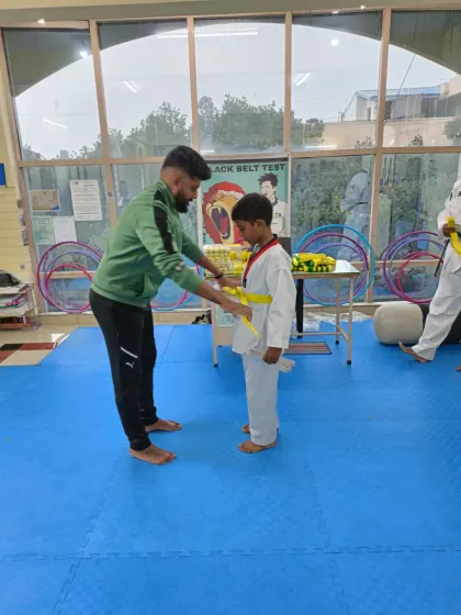 Tying a yellow belt.