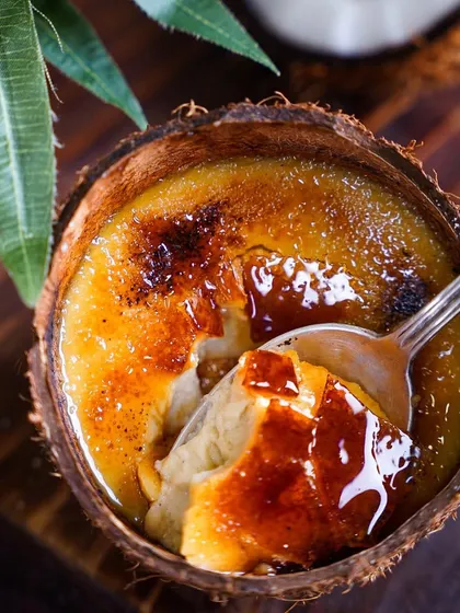 A spoonful of my Crème Caramel, revealing the smooth, creamy texture beneath the caramelized surface. I take pride in perfecting both Indian and international desserts for my clients.