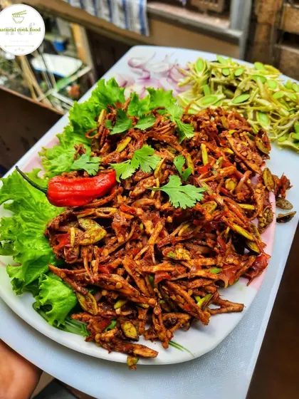 A seasonal specialty: 'Yongchak Singju', a spicy salad made with stink beans. It's a delicacy that is loved for its unique, pungent flavor.