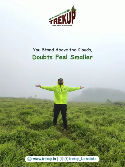 You stand above the clouds, and your doubts feel smaller. A trekker with arms outstretched, embracing the misty landscape.