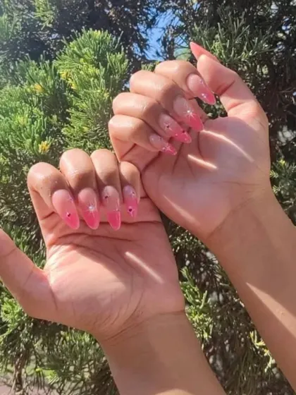 A client's sunny photo of her pink jelly nails with delicate rhinestone accents. The transparency of the jelly polish makes the gems stand out.