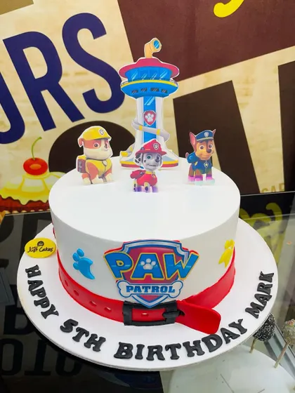 No job is too big, no pup is too small for this 3kg Paw Patrol cake. It features the Paw Patrol logo, a red fondant collar base, and character toppers of the heroic pups.