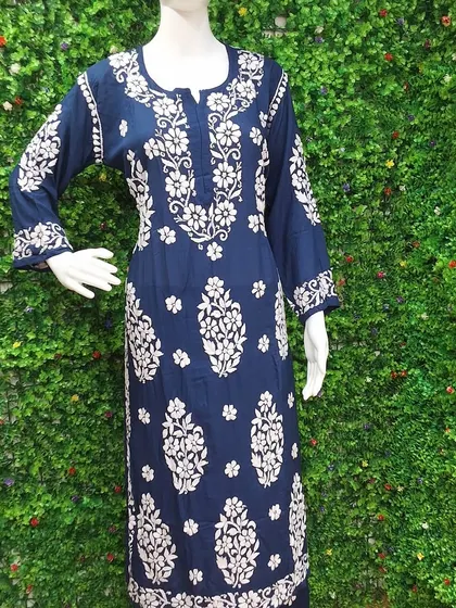 A classic navy blue Chikankari kurti with intricate white floral embroidery. This is a versatile piece that can be styled for both casual and semi-formal occasions.