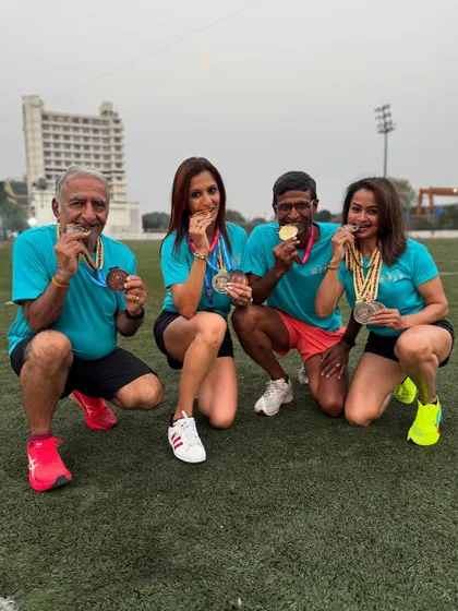 Biting the medals! A classic victory pose from our athletes after a successful national masters athletics championship.