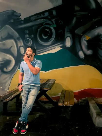 Me in front of a camera mural, lost in thought. A meta-moment for a photographer.