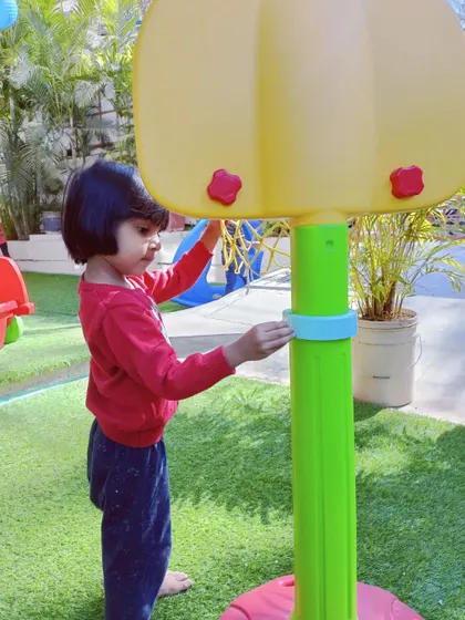 This little girl is helping to wipe down the basketball hoop. We believe in teamwork and keeping our space clean together.