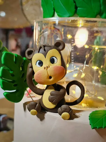A close-up of a cheeky monkey figurine for a jungle safari cake. Notice the textured fur and playful expression, details we focus on in my figurine workshops.