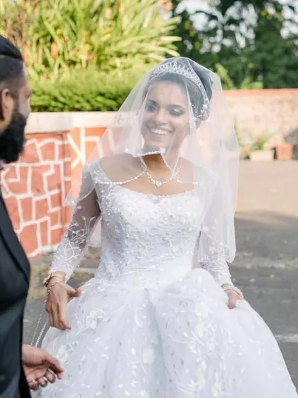 The bride's joyful expression as she approaches her groom for their first look. Her smile says it all, capturing the excitement of this private reveal.