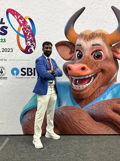 A full-length shot at the National Games venue, in front of the official branding.