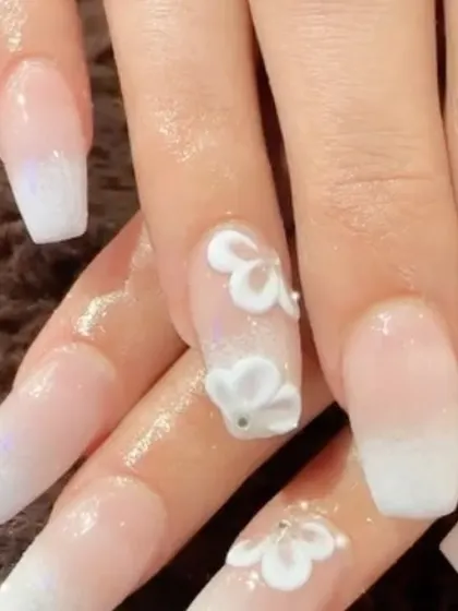 A classic wedding design with a twist. This set features a soft white ombre with beautiful 3D white flowers on the accent nails.