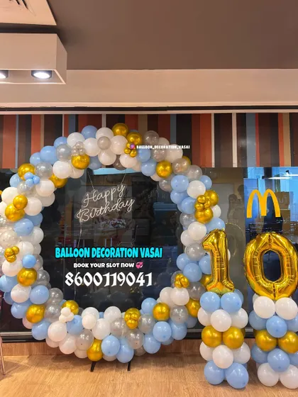A birthday celebration at a McDonald's outlet. We created a full ring of balloons in blue, white, and gold to make the party special.