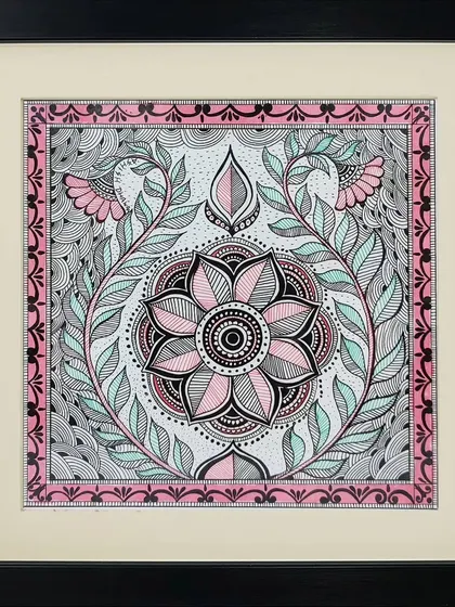 A floral mandala is the focus of this intricate Madhubani painting by Lakshit Mukhiya. The symmetrical design and use of pink, black, and mint green create a soothing and decorative effect.