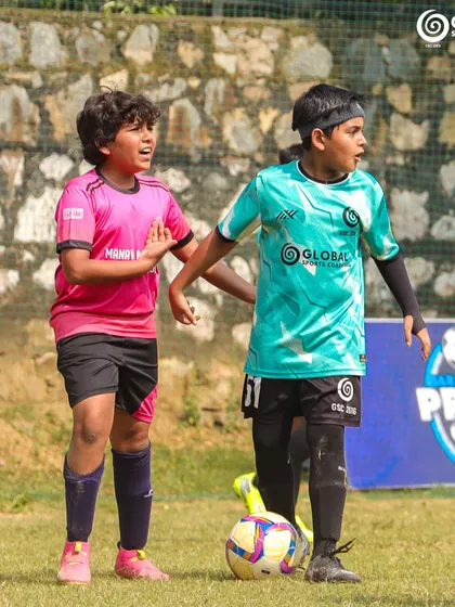 Two young players, one from GSC and one from Manav Rachna, focused on the ball.