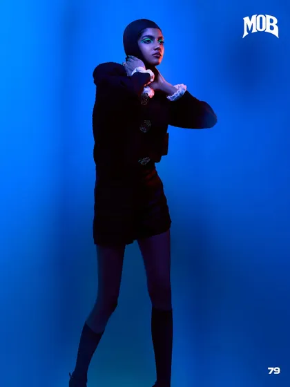 A profile shot from the "Neo-Baroque Noir" editorial, highlighted with blue and red gelled lights.