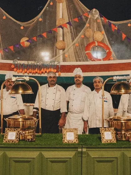 Our team of chefs at the 'Fish Shop' counter, set against a creatively designed boat backdrop. This highlights our flair for thematic and engaging food stations.