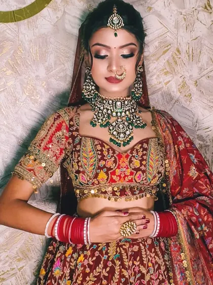 A detailed shot of the heavily embroidered blouse and the stunning green and polki necklace.