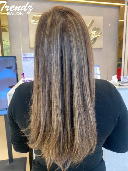 A fantastic example of a full head of highlights on long, straight hair. The blend of blonde and brown tones creates a beautiful, natural-looking result.