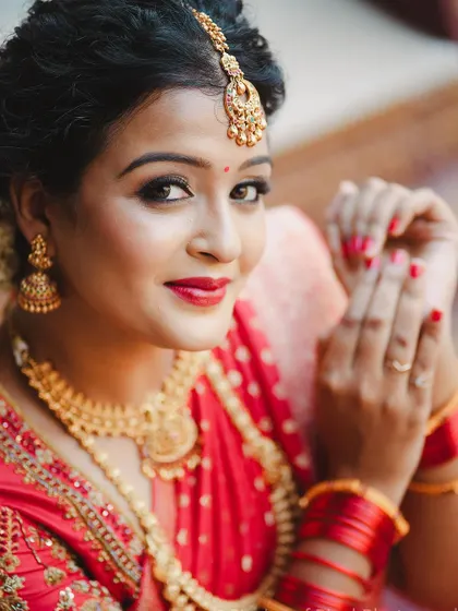The subtle smile and classic pose highlight the beauty of the entire bridal ensemble.