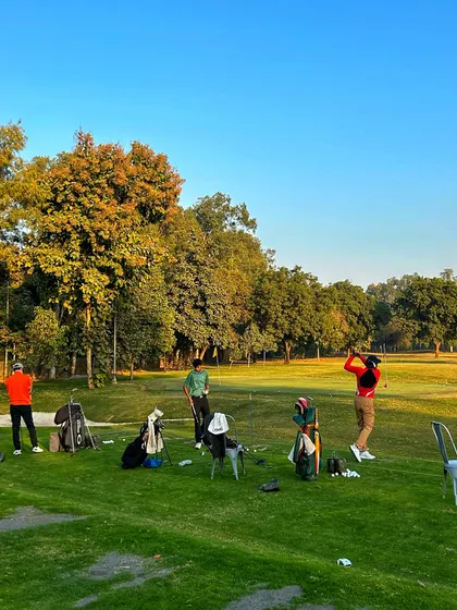 A group of friends enjoying a beautiful, sunny day on the driving range.