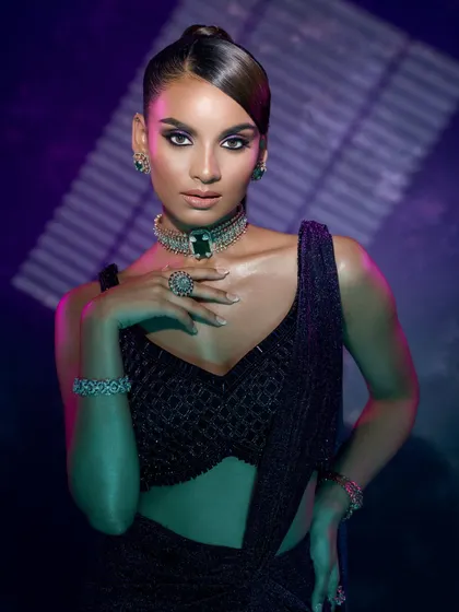 A mid-shot using dual-toned lighting, with purple and green hues, to create a futuristic and vibrant editorial look.