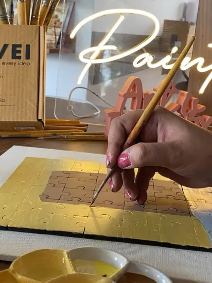 A close-up of the puzzle painting process. The wooden puzzles from our partner provide a great surface for painting.