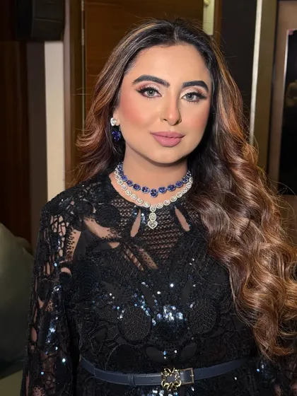 The focus is on the eyes and the stunning jewelry. The makeup is blended perfectly to create a sophisticated and alluring effect.