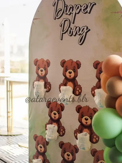 A "Diaper Pong" game, a fun and popular activity for baby showers. The board is decorated with cute teddy bears, tying it into the overall theme of the event.