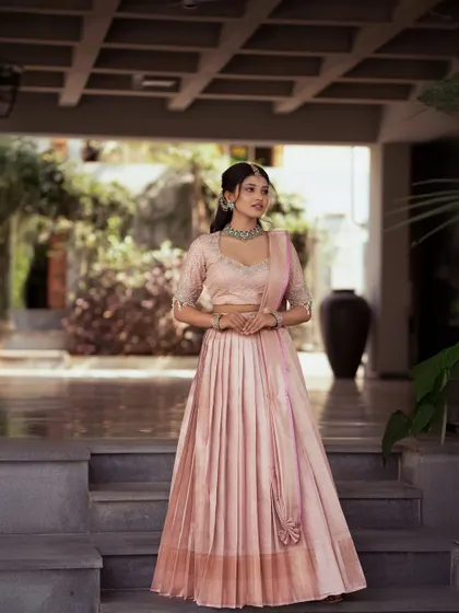A full view of the pastel pink half saree, showing its graceful silhouette. This is a perfect choice for a daytime wedding or an engagement ceremony.