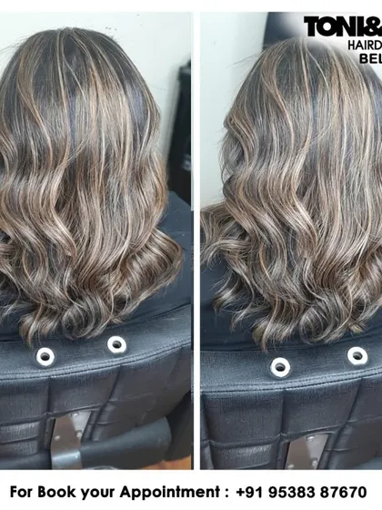 This client wanted a significant change with highlights. We created this high-contrast look with blonde highlights on a dark base, styled into waves to blend the colors and add texture.