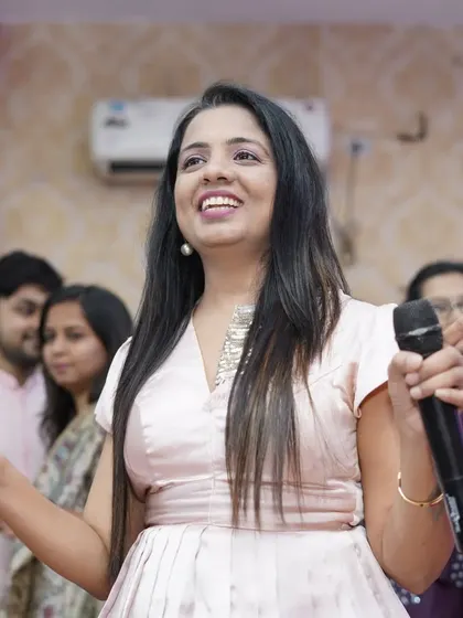 A close-up shot of me in action, mic in hand, at a baby shower. I am passionate about my work and love bringing energy and excitement to every celebration.