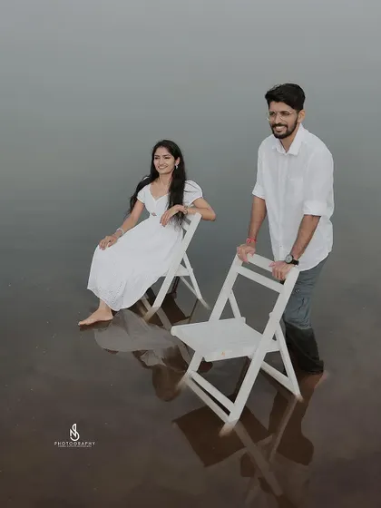 A duplicate of 305, a creative shot with the couple and chairs in the lake water.