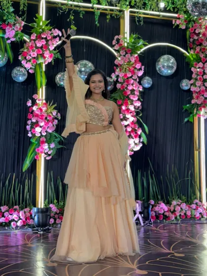A cheerful pose in my peach gown, ready to take the stage for a night of Sangeet performances.